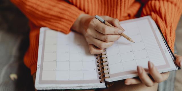 Woman writing on her daily planner